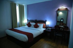 A bed or beds in a room at The Ruby Arena