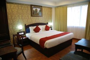 A bed or beds in a room at The Ruby Arena