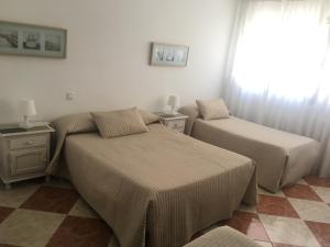Posteľ alebo postele v izbe v ubytovaní Hostal Jomarijo