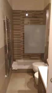 a bathroom with a toilet and a bath tub at Apartment Corso Cavour in Bari