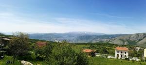 Ein Haus auf einem Feld mit einem Berg im Hintergrund in der Unterkunft Bacca Blu in Villa Santa Lucia degli Abruzzi + 9 Fotos