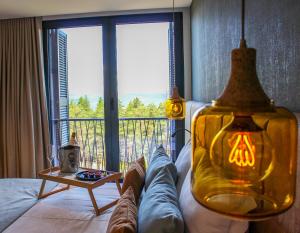 a room with a bed with a view of a balcony at Pena Park Hotel in Ribeira de Pena