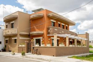 a large orange building with bikes parked in front of it at B&B Kilometrozero in Supersano