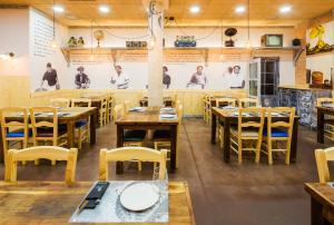 a dining room with wooden tables and chairs at A Feira Posada in Overo