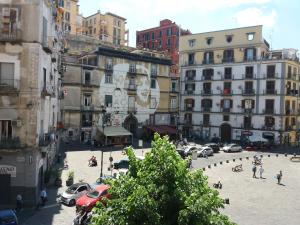 a city with cars parked in a street with buildings at Casa Fiore in Naples