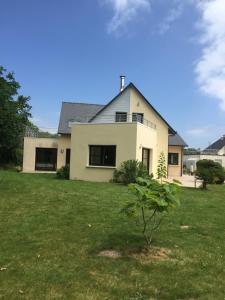 a white house with a tree in a yard at Villa Benodet in Bénodet +17 photos