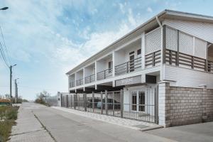 a white building on the side of a street at SeaZone in Zatoka