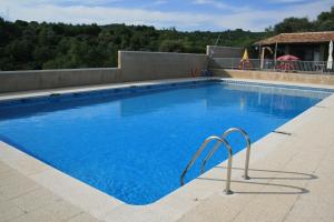 a large swimming pool with blue water at Mesón de Colungo in Colungo
