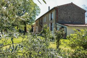 an old house with a garden in front of it at La Bastide De Negra in Montesquieu-Lauragais