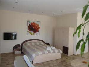 a bedroom with a bed and a chair in it at Vila Laima in Šventoji