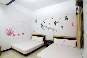 Postel nebo postele na pokoji v ubytování Luyi Ludao B&B