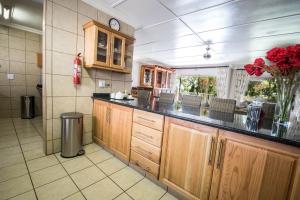 a kitchen with wooden cabinets and a counter top at First Group Lake View Cabanas in St Lucia