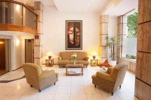 a living room with two couches and a table at Hotel Princess in Mendoza