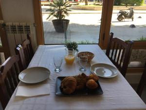 a table with a plate of food and orange juice at Hotel la Masia in Portbou