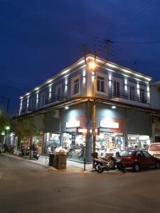 a motorcycle parked in front of a building at night at TheJoy City Suites in Chania