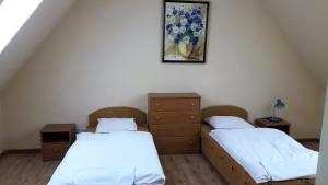 dwa łóżka w pokoju z obrazem na ścianie w obiekcie Apartamenty Gościnne Med-Palace w mieście Niemodlin