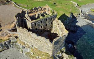 an aerial view of an old castle on a cliff at Mingary Castle - Restaurant with Rooms in Kilchoan