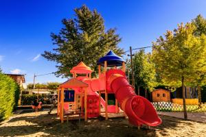 a playground with a slide in a park at Camping Village Butterfly in Peschiera del Garda