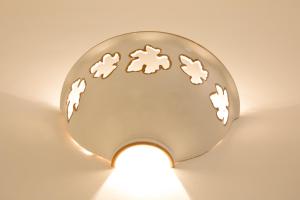a light illuminating a metal plate with cookies on it at Antica Masseria Ficazzana - Tenuta in Marina di Pescoluse