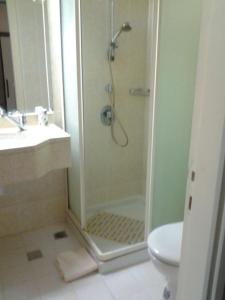 a bathroom with a shower and a sink and a toilet at Rosary Sister Guest House Ein Karem in Jerusalem
