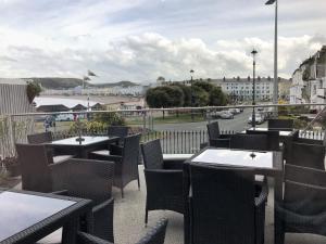a restaurant with tables and chairs and a view of a street at Belmont Llandudno in Llandudno