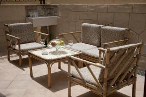 two chairs and a table with wine glasses on it at Arcadia in Tropea