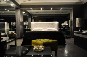 a bedroom with a bed and a table in it at Andromeda Hotel Thessaloniki in Thessaloniki