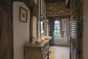 a bathroom with a sink and a counter in a room at Fawsley Hall Hotel in Daventry