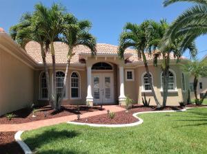 a house with palm trees in front of it at Villa Cape Florida in Cape Coral