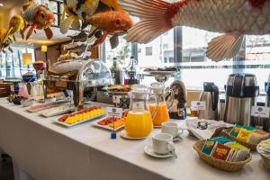 a buffet with food and orange juice on a counter at Allpa Hotel & Suites in Lima