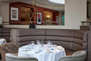a table with glasses on it in a restaurant at Sir Christopher Wren Hotel in Windsor