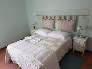Postel nebo postele na pokoji v ubytování Agriturismo La Quiete