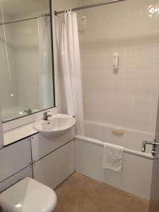 a white bathroom with a sink and a toilet at St. Margaret's Hotel in Saint Margaretʼs at Cliffe