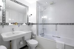 a bathroom with a toilet and a sink and a shower at Sir Christopher Wren Hotel in Windsor
