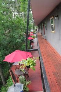 a row of tables and chairs with umbrellas on a porch at Brydan Suites in Eureka Springs