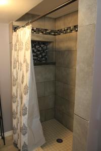 a shower with a shower curtain in a bathroom at Brydan Suites in Eureka Springs