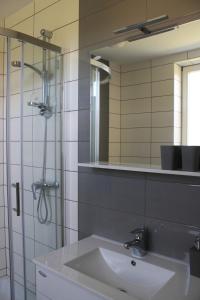 a bathroom with a sink and a shower and a mirror at Yellow Dreamhouse in Postojna