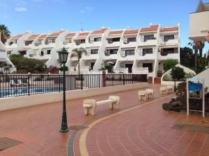 a street light and benches in front of a building at New cozy flat with pool in amazing place..! in Costa Del Silencio