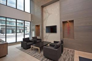 a living room with two chairs and a table at Royal Stays Furnished Apartments - Square One in Mississauga