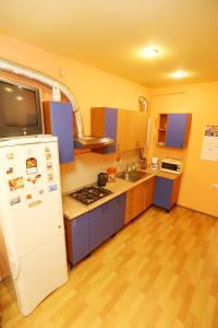 a kitchen with a white refrigerator and a sink at MANGO SPb in Saint Petersburg