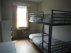 a room with two bunk beds and a window at Apartments Iris in Ostend