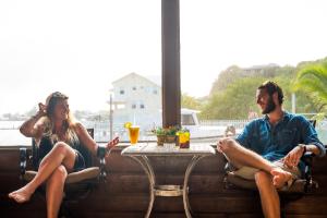 a man and a woman sitting at a table at Utila Lodge in Utila