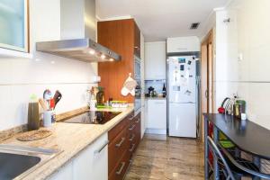 a kitchen with a sink and a refrigerator at Biopark View Apartment in Valencia