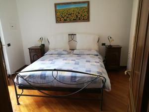 a bedroom with a bed with a picture on the wall at Pellico Apartment in Brusaporto