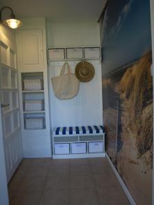 a room with a closet with a purse on the wall at Biały Domek in Stegna