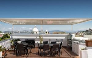 a patio with a table and chairs on a roof at Gioia 13 Rooms & Apartments in Procida