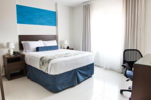 Uma cama ou camas num quarto em Hotel Latitud 15
