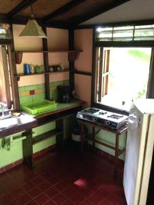 a kitchen with a counter and a sink and a stove at Casita Rolando in Puerto Viejo