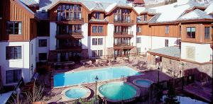 a large building with a swimming pool in front of it at The Residences at Mountain Lodge by Hyatt Vacation Club in Beaver Creek