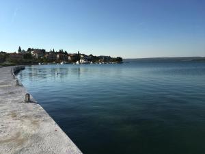 a large body of water with houses in the background at Apartmani Nikolina Seaview in Šibenik